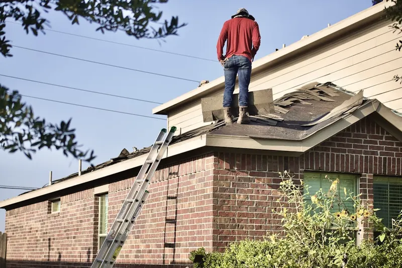 Professional roofer working on a residential roof in Paris Court East